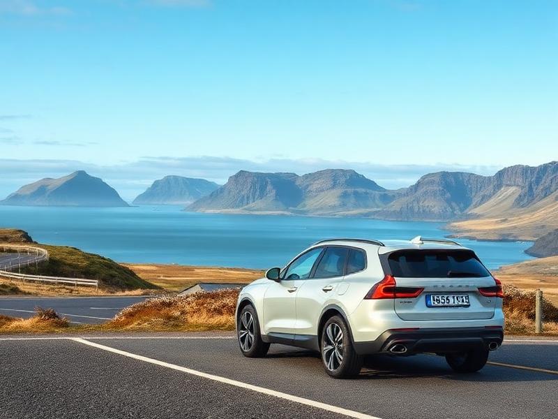 Rental car beside an Icelandic coastal road with mountains